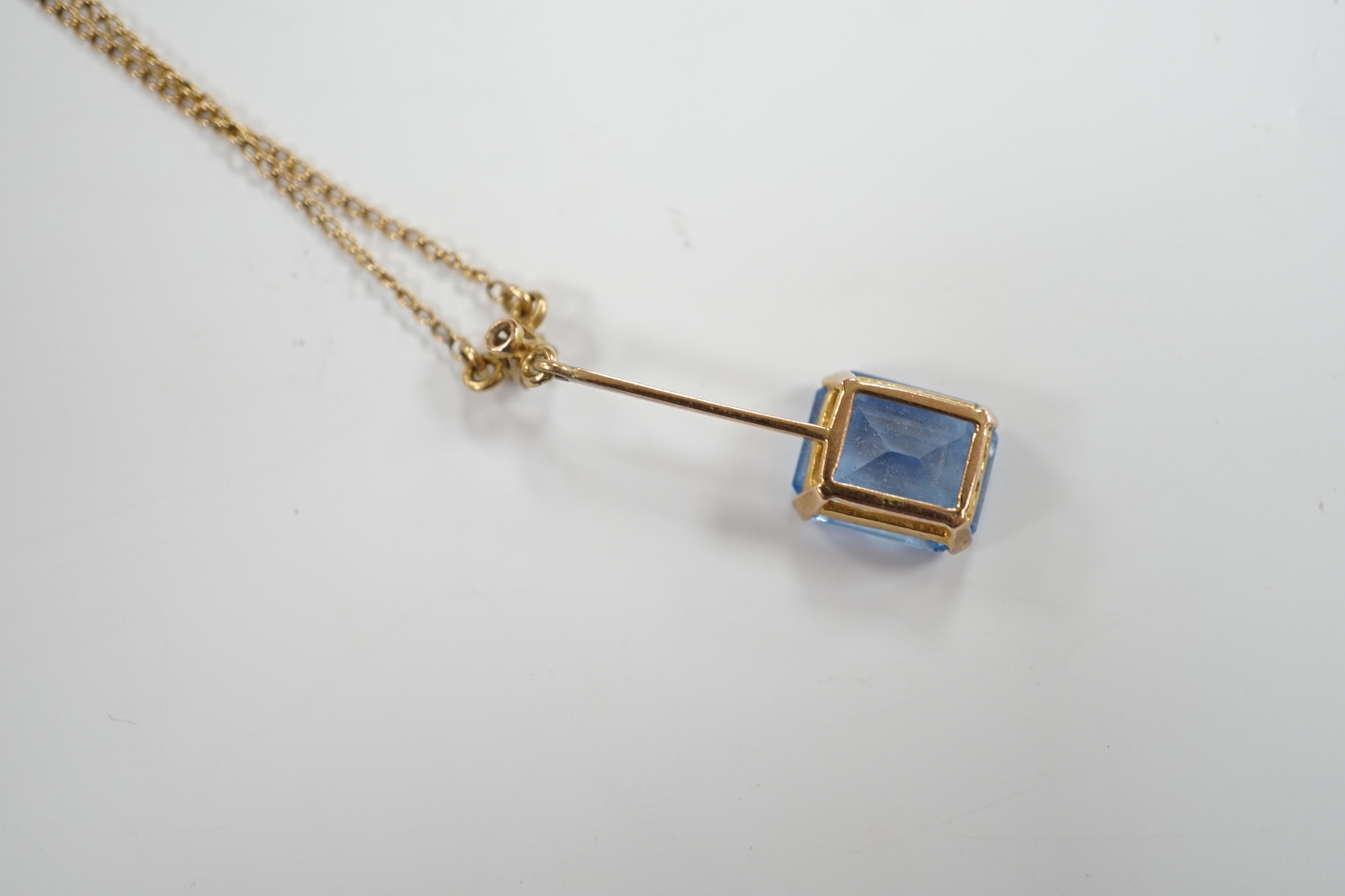 A 9c, single stone synthetic blue spinel and single stone diamond set drop pendant necklace, 44cm, gross weight 4 grams.